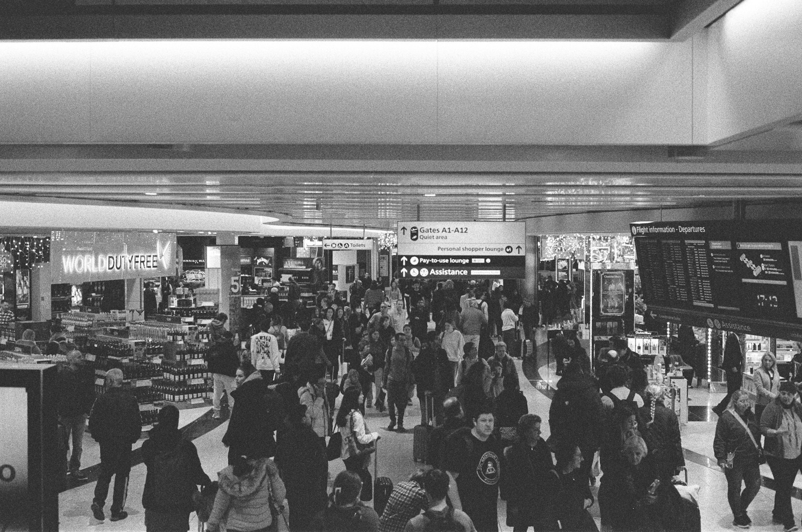 Travellers moving through a busy airport terminal, reflecting US service challenges and customer experience transformation.